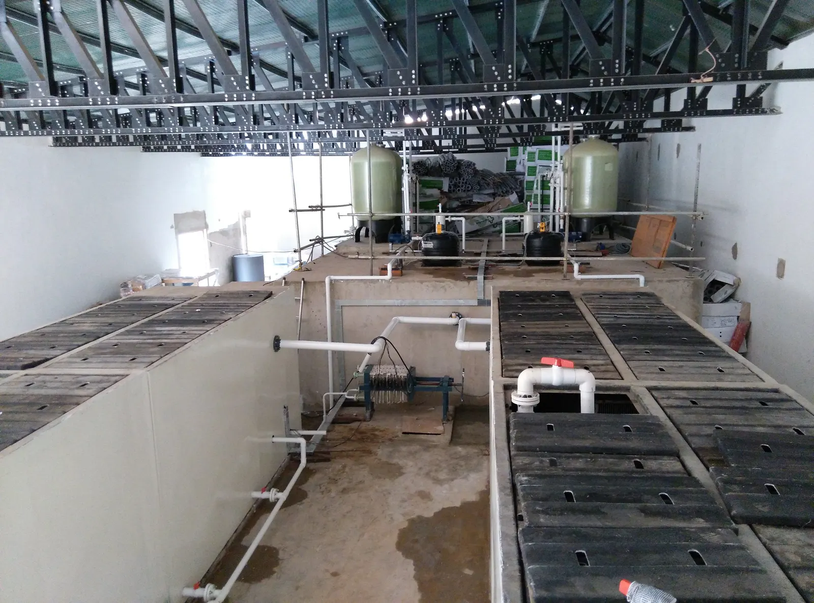 Tanks of a sewage treatment plant inside a hall